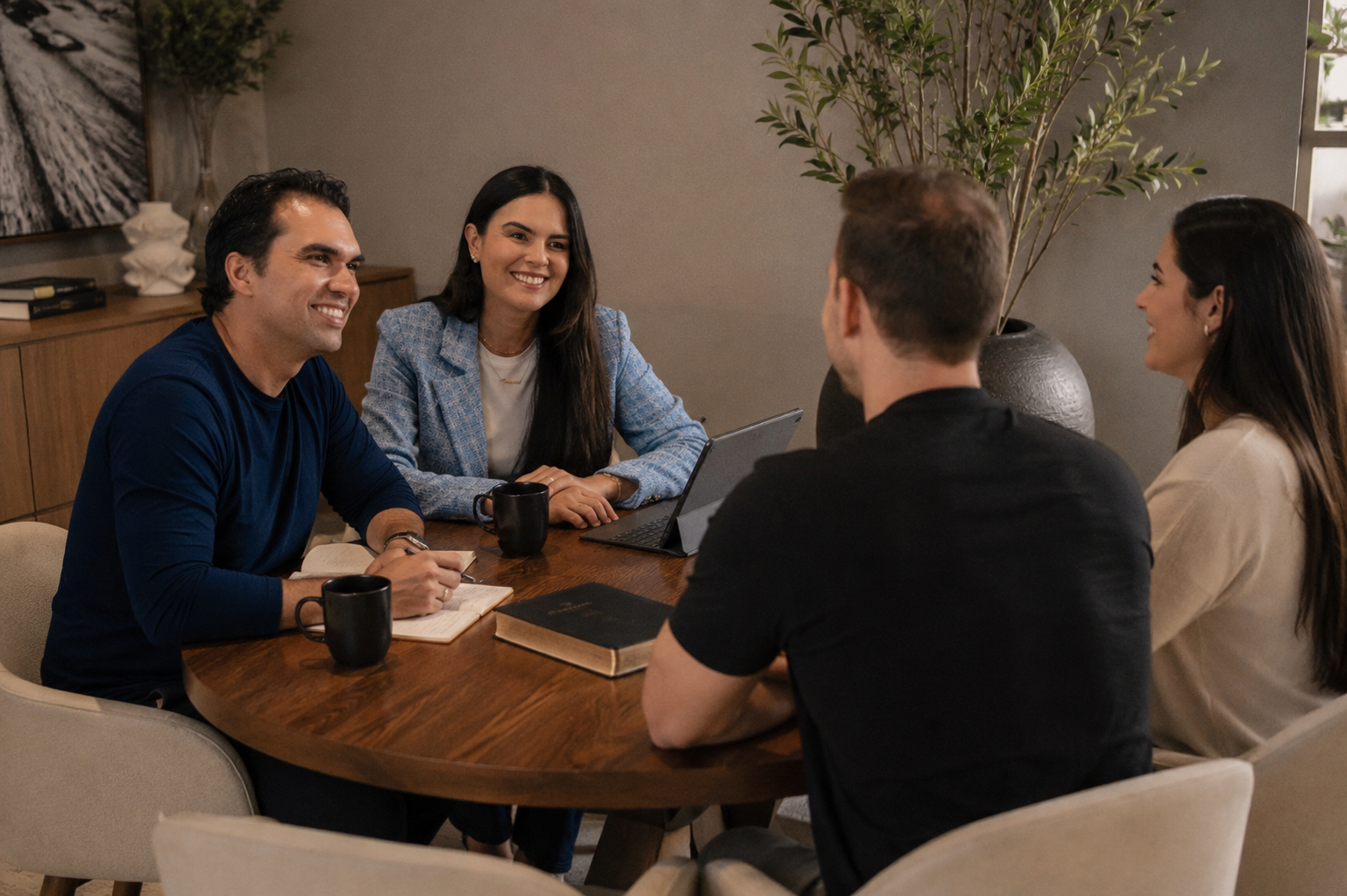 Marcos e Viviane Leal sentados à mesa conversando com um casal